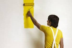Young Man Painting Wall